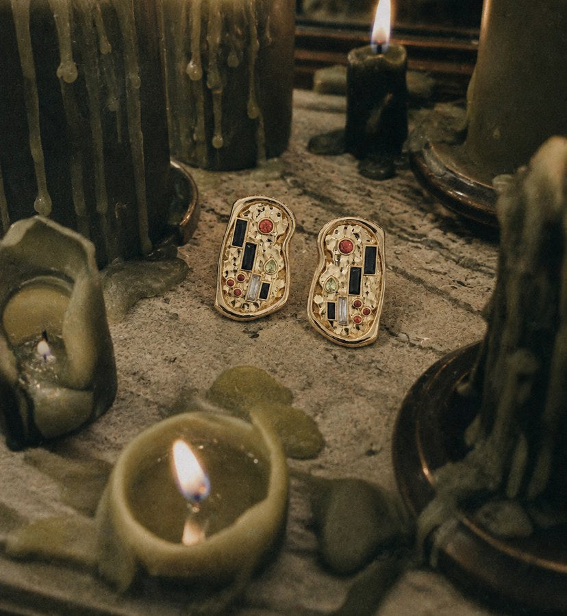 The Kiss Earrings among candles